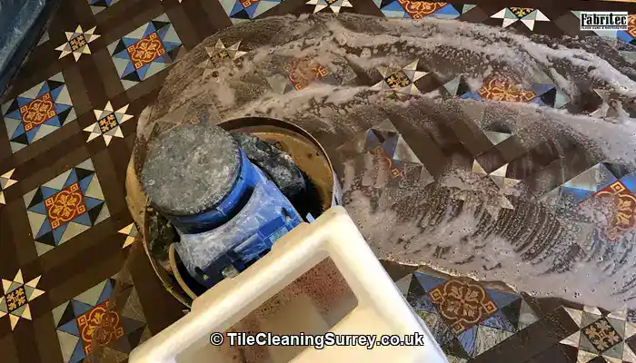 Professional restoration work being carried out on Victorian floor tiles.